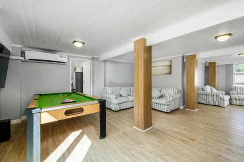 a living room with a ping pong table in it at The Slipway in Colchester
