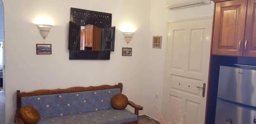 a room with a couch and a mirror on the wall at LOURANTIANIKA HOUSE in Kýthira