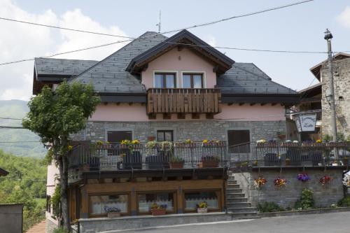a house with a balcony with flowers on it at Locanda Zita in Sestola