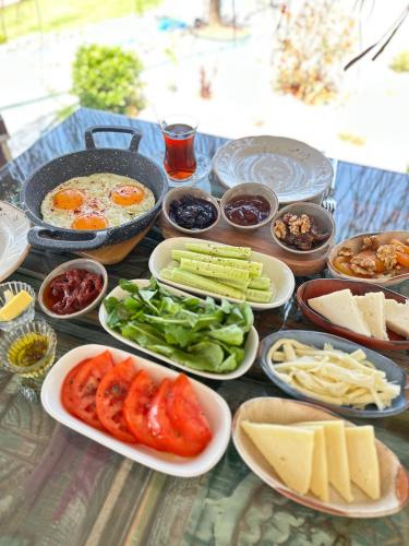 a table topped with plates of food on a table at ELIES TINY GLAMPING in Ayvalık