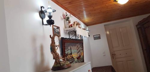 a living room with a wooden ceiling and a door at LOURANTIANIKA HOUSE in Kýthira