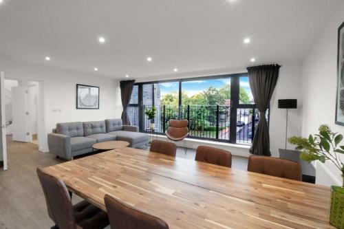 a living room with a table and a couch at Modern Penthouse in Wembley in London