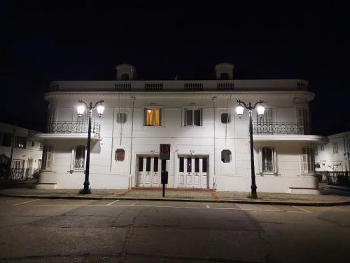 a white building with two street lights in front of it at RESIDENCIAL METRO REPUBLICA in Santiago