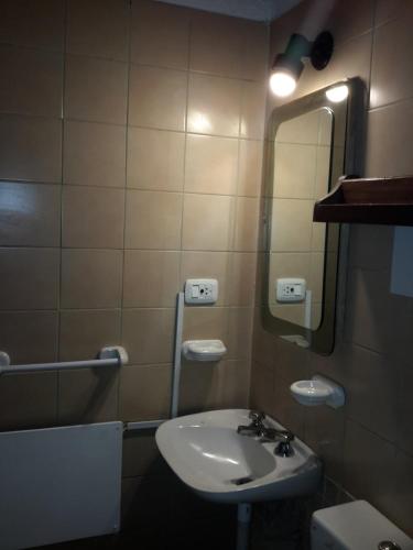 a bathroom with a sink and a mirror at Cabaña en Alta Montaña - Complejo Cabañas del Pastizal - USPALLATA, MENDOZA in Uspallata