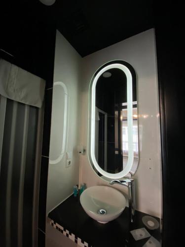 a bathroom with a sink and a mirror at Fontush Boutique Hotel in Ivano-Frankivsʼk