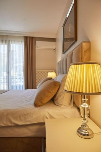 Postel nebo postele na pokoji v ubytování Kaira Hotel& Aparts