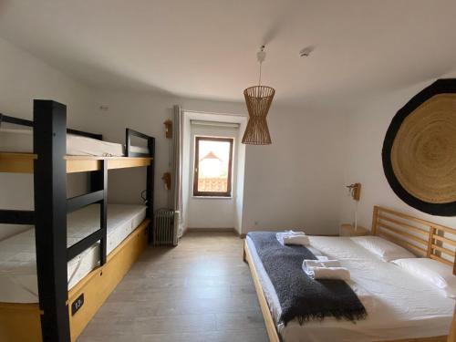 a bedroom with two bunk beds and a window at Amazigh Hostel & Suites in Aljezur