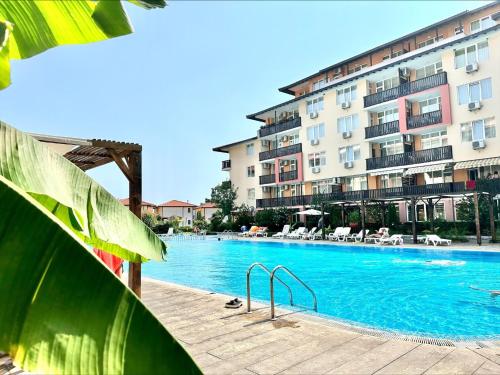 a large swimming pool in front of a building at Chateau Aheloy 2 - Menada Apartments in Aheloy
