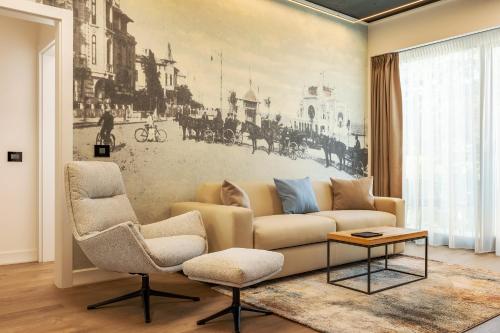 a living room with a couch and two chairs at Rosetti One in Constanţa