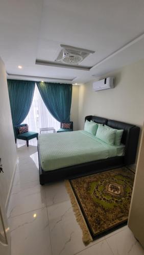 a bedroom with a bed and a large window at C Suites in Lahore