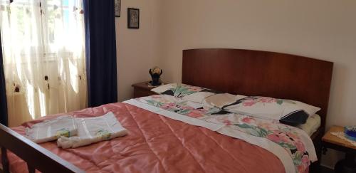 a bed with two pillows on it in a bedroom at LOURANTIANIKA HOUSE in Kýthira