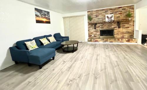 a living room with a blue couch and a fireplace at Downtown in Plano in Plano