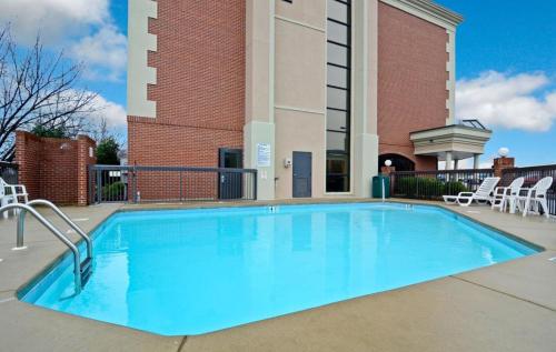 einem Pool vor einem Gebäude in der Unterkunft Clarion Pointe Greensboro Airport in Greensboro