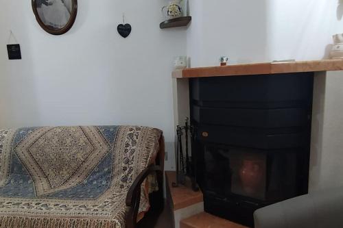 a living room with a bed and a fireplace at RosaLilli in Locorotondo