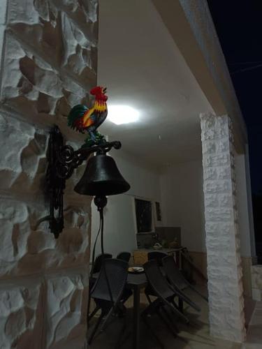 a room with a table and a chicken on a wall at RosaLilli in Locorotondo
