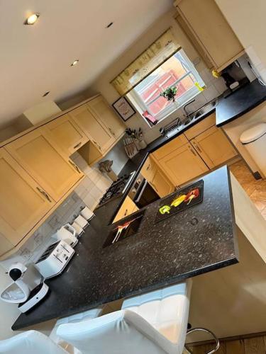 an aerial view of a kitchen with a black counter top at JB Stays Croydon Townhouse in South Norwood