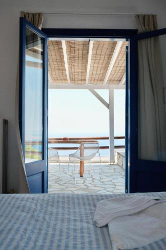 a bedroom with a bed and a view of the ocean at Alia's sea view villa & studios in Apróvaton
