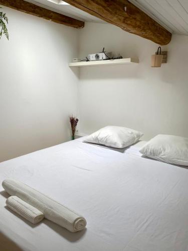 a white bed with two pillows on top of it at Chambre in Auterive
