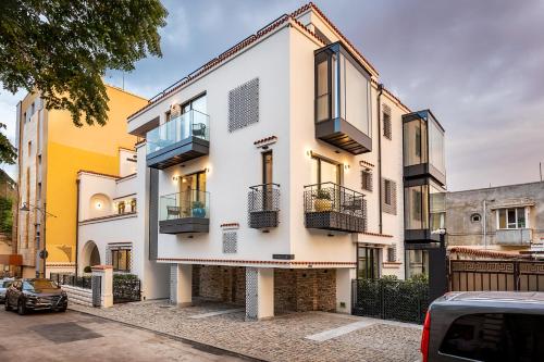 a white building with balconies on a street at Rosetti One in Constanţa