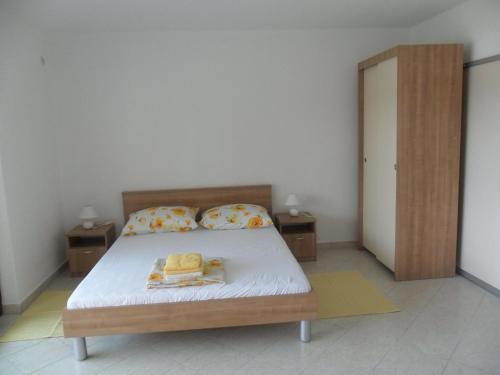 um quarto com uma cama com duas almofadas em Mar Eva Apartment em Rab
