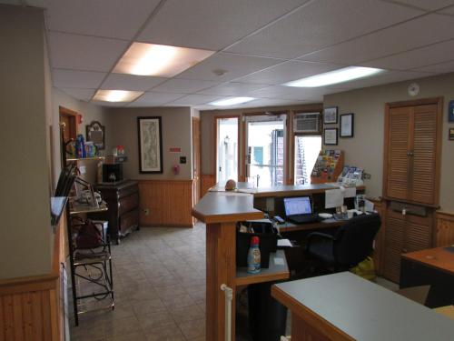 an office with a desk with a laptop on it at The Lake George Inn in Lake George