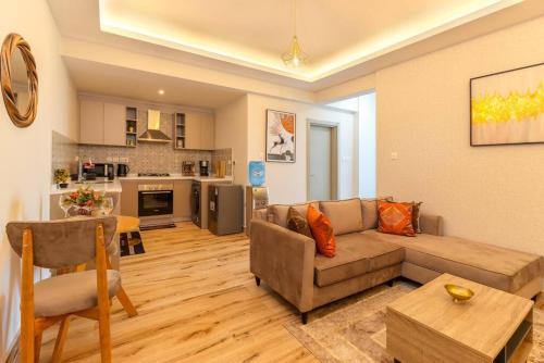 a living room with a couch and a kitchen at 1 bedroom Condo in Westlands with Pool and Gym in Nairobi