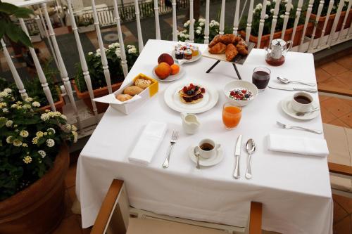 a white table with breakfast foods on it at Hotel Residence in Amalfi
