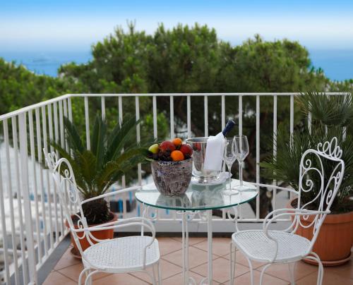 a table with a bowl of fruit on a balcony at Hotel Residence in Amalfi