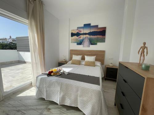 a bedroom with a bed and a large window at El rincón de Vejer. Vistas exclusivas y únicas. in Vejer de la Frontera
