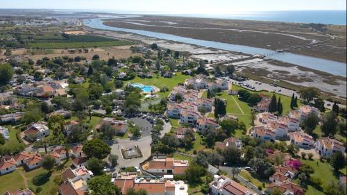 an aerial view of a residential suburb next to a river at Pedras D'el Rei in Tavira