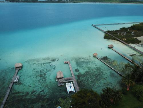 an aerial view of a dock in the water at Cabañas Hostal & Camping Magic Bacalar in Bacalar