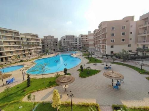 an apartment complex with a large swimming pool at Pyramids and Museum Resort Apartment in Giza