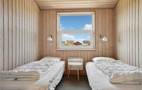 a row of beds in a room with a window at Stunning Home In Thisted With 4 Bedrooms, Sauna And Wifi in Nørre Vorupør