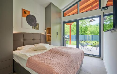 a bedroom with a bed and a sliding glass door at Pet Friendly Home In Brezova Gora With House A Panoramic View 