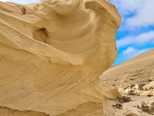 a rock formation in the desert with a blue sky at Premium Residence Isabel in Costa Calma