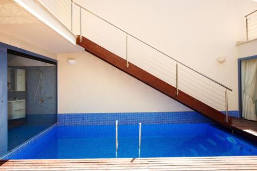 a swimming pool with a staircase in a building at Premium Residence Isabel in Costa Calma