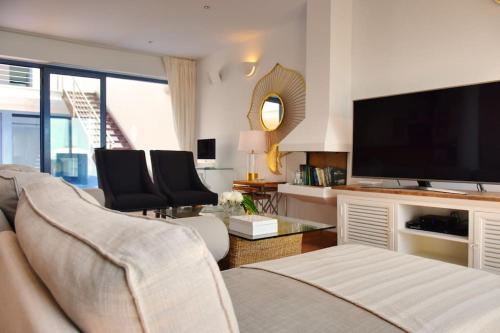a living room with a couch and a flat screen tv at Premium Residence Isabel in Costa Calma