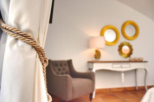 a room with a chair and a table with mirrors at Premium Residence Isabel in Costa Calma