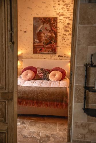 a bedroom with a bed with two pillows on it at La Maison d'Horbé in La Perrière