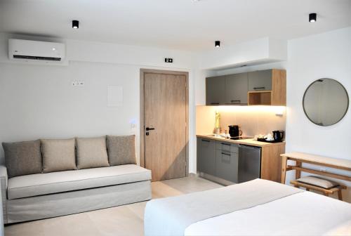a bedroom with a bed and a small kitchen at La Mer Luxury Apartments in Ierissos