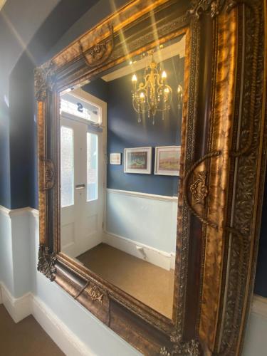 a large mirror in a room with a chandelier at Blue Sky Guest House in Brighton & Hove