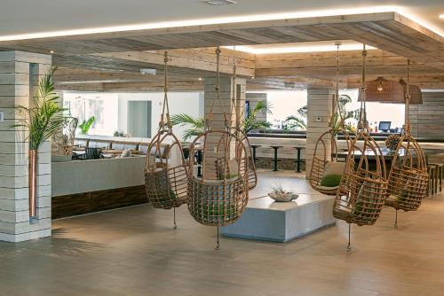 a room with several rattan chairs hanging from the ceiling at Amara Cay Resort in Islamorada