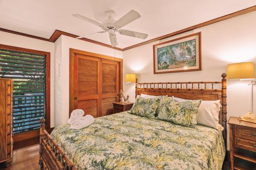 um quarto com uma cama e uma ventoinha de tecto em Kiahuna Plantation Renovated 1br, Private Lanai, AC 411 em Koloa