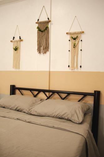 a bed with curtains and other decorations on the wall at Departamento Orellana 5 in Chetumal