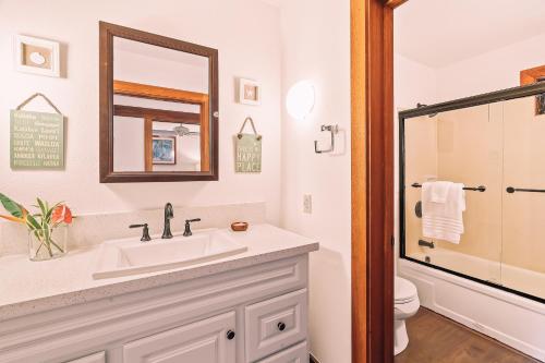 a white bathroom with a sink and a mirror at Kiahuna Plantation Renovated 1br, Private Lanai, AC 411 in Koloa