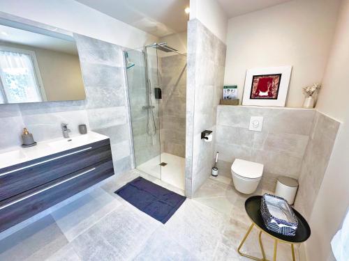 a bathroom with a shower and a toilet and a sink at Le Repos du Keyrié in Saint-Marc-Jaumegarde