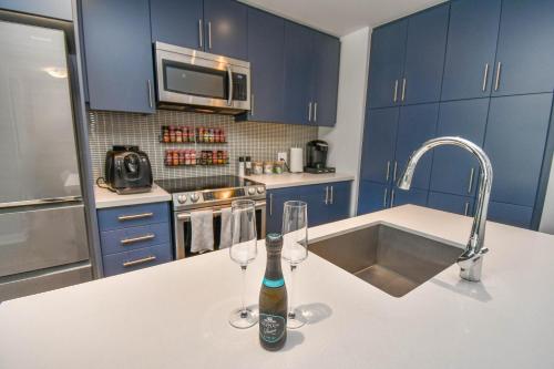 a kitchen with two wine glasses and a bottle on a counter at King & Queen Bed, Pool, Firepit, Fully Stocked in Innisfil