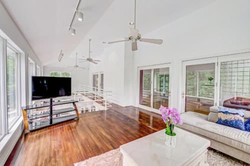 a living room with a couch and a tv at Tranquil Bays Estate in Hampton Bays