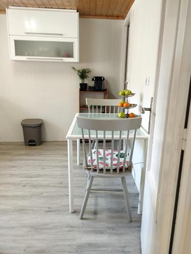 a white table and a chair in a kitchen at Casa Aldea de Abaixo in Lugo