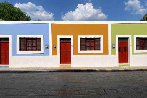 a colorful building with red doors on a street at Trilliza-Verde in Campeche